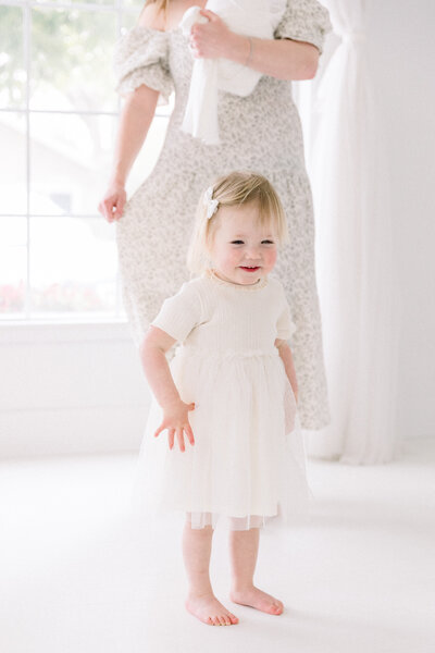 toddler girl in white dress in studio taken by Sacramento Maternity Photographer Kelsey Krall