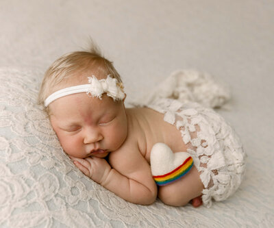Photo of a baby girl laying on a flokati rug in an Erie PA Photography Studio