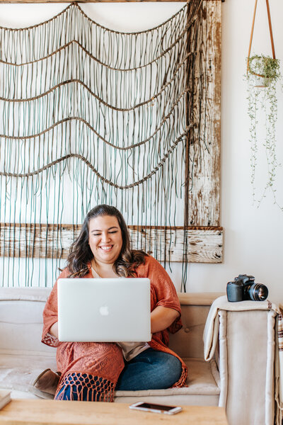 girl sitting on sofa on laptop