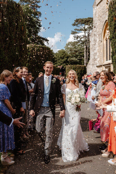 Kirsty and Jack Wedding Ceremony confetti kiss. Bride wearing Josephine Scott  Constance dress