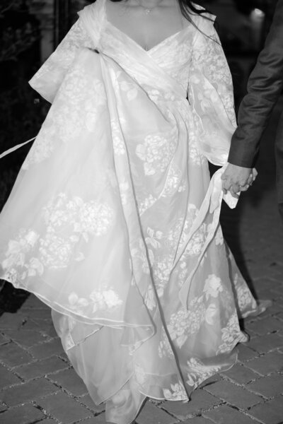 bride and groom holding hands