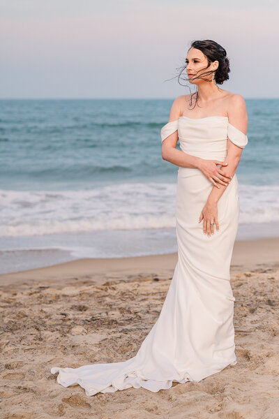 A brunette bride on the Wilmington beach for her bridal portraits at sunset enjoying her Wilmington wedding photography by JoLynn Photography