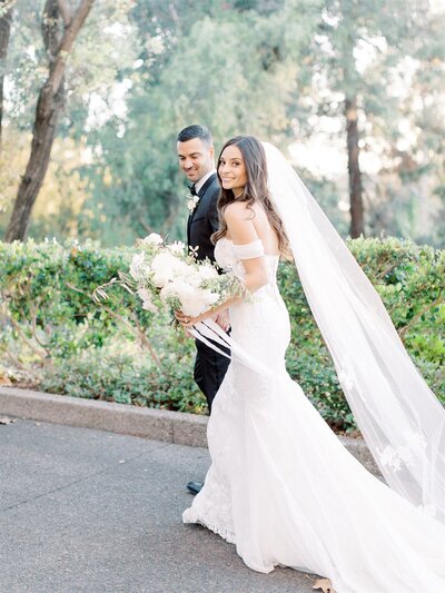 A full white bouquet held by the bride.