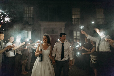 bride and groom exit with sparklers
