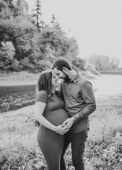 Black and white image of pregnant couple by family portrait photographer vancouver