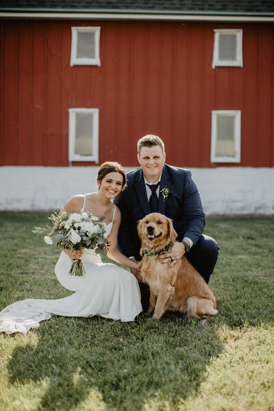 bride and groom holding dog