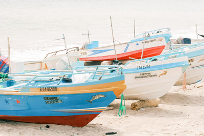 Brightly colored boats pulled onto the sand