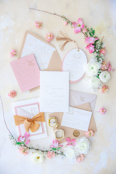 luxury invitation suite flat lay with pink and white flowers