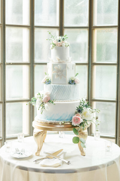 wedding cake in front of window