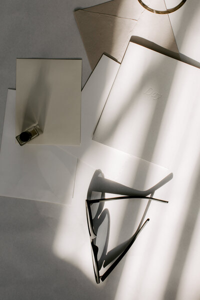 Glasses on papers strewn about