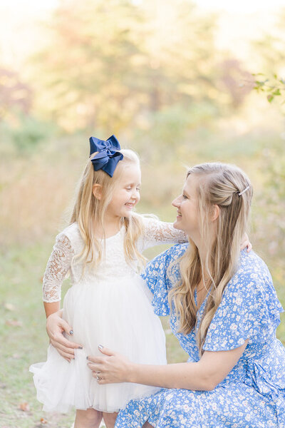 mom and daughter looking at each other during family photos in Chantilly, Virginia taken by a NoVa family photographer