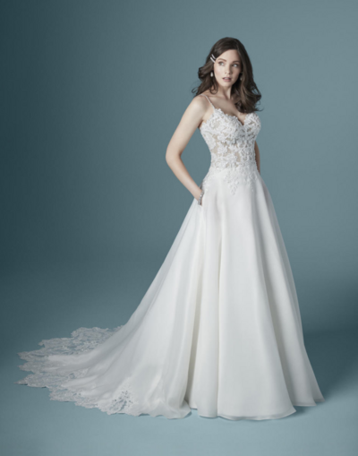 A-Line Wedding Dress. This A-line wedding dress is lovely and romantic. You'll be dizzy with compliments on the train—an illusion lace hemline cut in the shape of a dahlia.