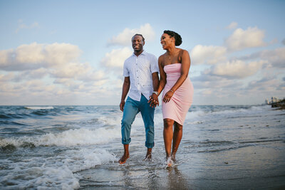 BIPOC Couple enjoying the beach in Florida for their Engagement Photos in Georgia