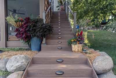 Black horizontal stair riser lights on TimberTech Advanced PVC deck staircase. 
