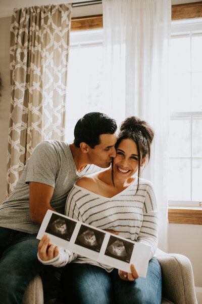 couple holding ultrasound photo