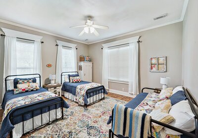 Bedroom with two twin beds and a full-sized daybed in historic vacation rental home in downtown Waco, TX