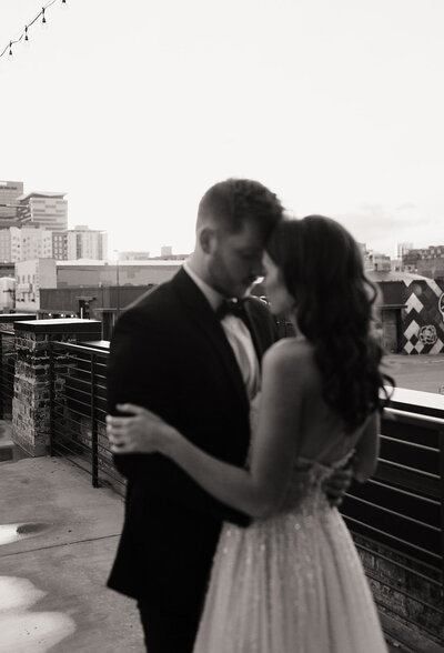 couple hugging on a rooftop on wedding day in Colorado