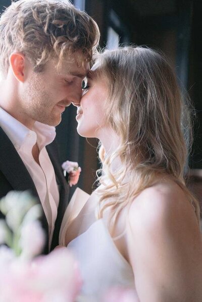 Couple-touching-noses-in-Hotel-Jerome-in-Aspen-Colorado.jpg