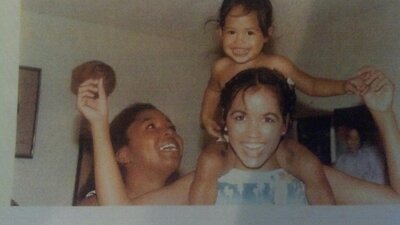 Lynnette on her moms shoulders when she was little
