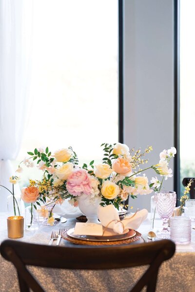 fresh flowers sit in a compote on a table at a wedding reception at The Luminaire in Houston Texas by Swish and Click Photography