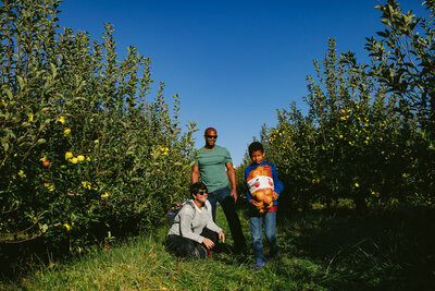 Family of three in an orchard in upstate New York