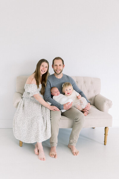 photo of family sitting on the floor of nursery with dog and newborn baby, taken by Kelsey Krall Maternity Photography Sacramento