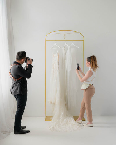 kaylyn leighton's back to the camera as she steams wedding gown for a client.