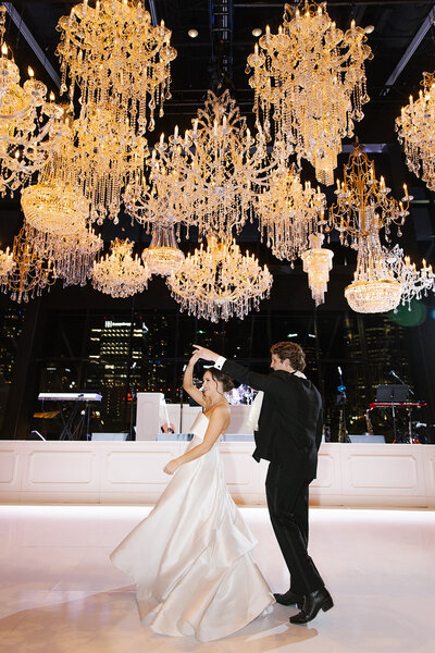 cluster of chandeliers hanging over wedding dance floor