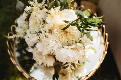 Bouquet rests on a mirror top table at Biltmore Estate Micro Wedding in Asheville, NC.