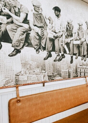 Interior wall mural on men dining and relaxing on city skyscraper with shot of interior modern seating