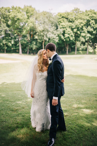 Bride and groom kiss in a quiet intimate moment