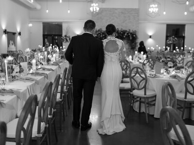 First dance in front of fireplace on black and white dance floor