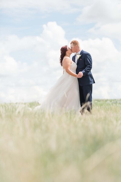 wedding photo taken in a open grassy plain