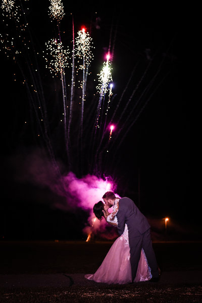 Couple kisses in front of fireworks, New Years Eve Wedding,  Mississippi Wedding