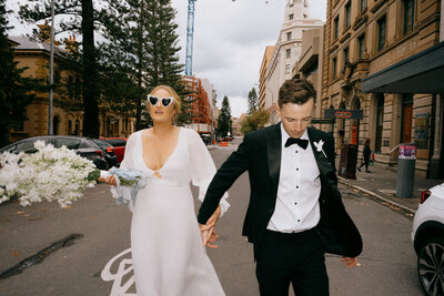 Nicky & Jake on their wedding day, walking through the streets of Newcastle