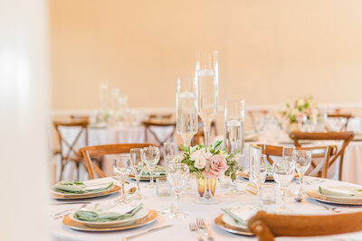 Soft pink and cream table settings at a wedding reception.