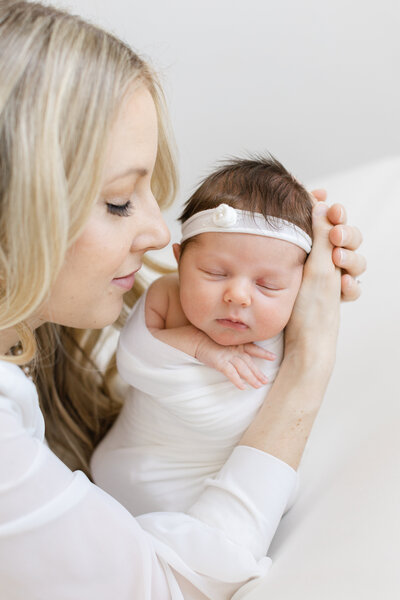 New mom holding newborn in studio portrait session in Pittsburgh, PA