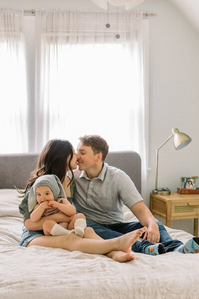 Family snuggles in bed during lifestyle family session photographed by Lexington Kentucky film  photographer Magnolia Tree Photo Company