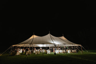 Reception tent at night in dark with lights, Buxton School wedding