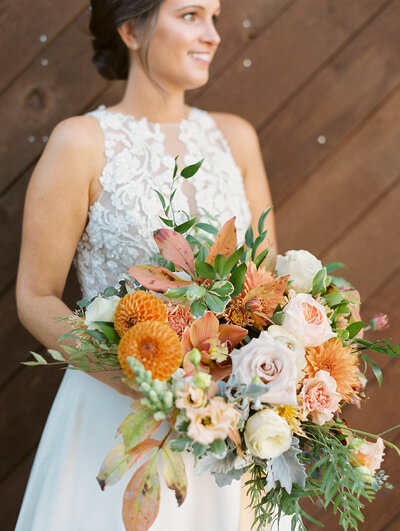bride looking off into the distance with wedding bouquet in hand
