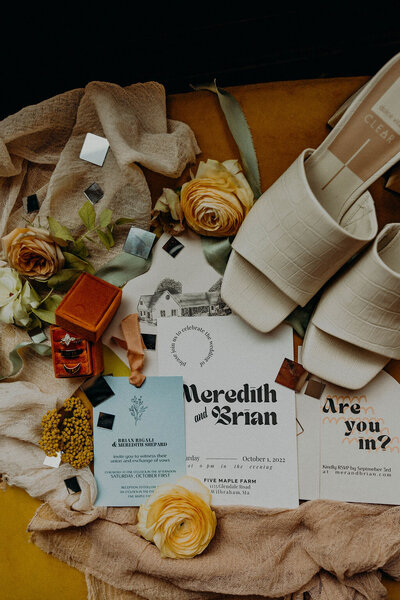 Photo of details, invitation, rings, wedding heels, and more