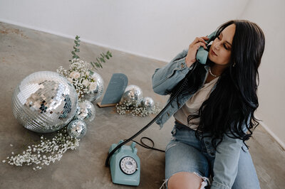 A girl holding a telephone
