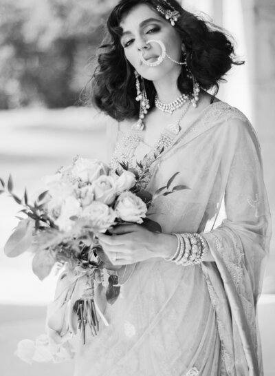 Woman in a Saree Holding a Bouquet, by La Rue Events