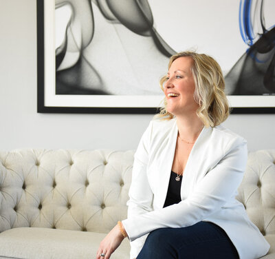 life coach sitting on couch in white blazer