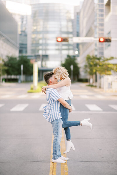 couple kissing during downtown engagement