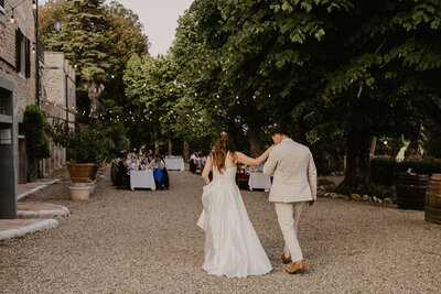 Bride and Groom walking toward their wedding reception
