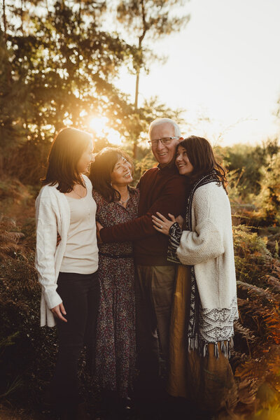 family photoshoot outside girl in blanket field