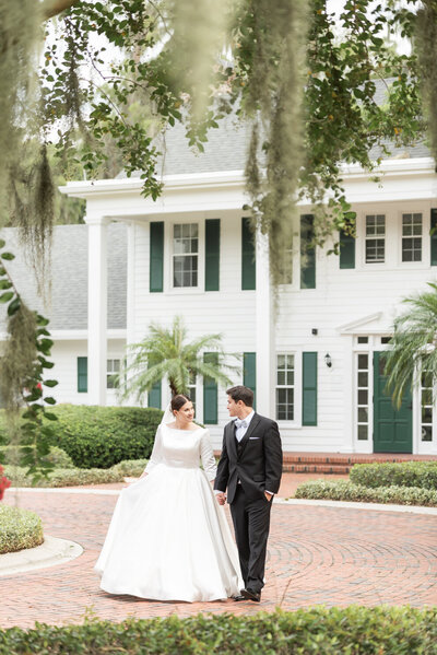 Married couple walking together at cypress grove estate