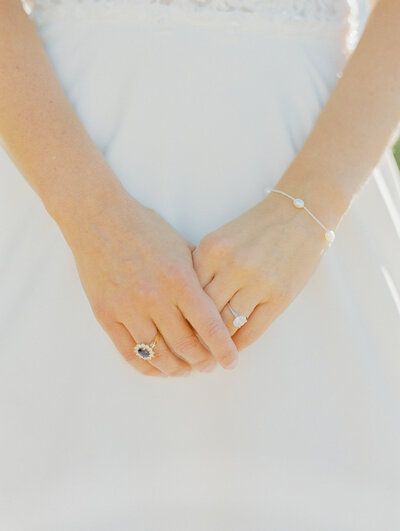 bride holding hands and showing wedding ring off
