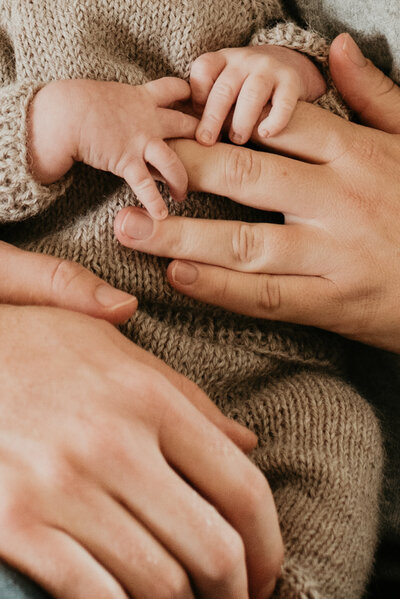 newborn holding fingers